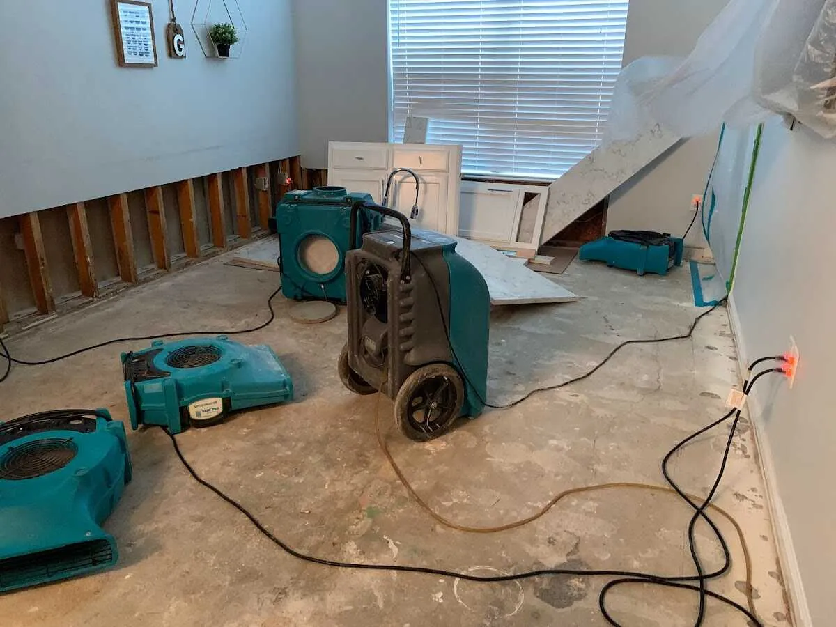 Dehumidifier in flood-cut room for Water Damage Restoration in Welcome